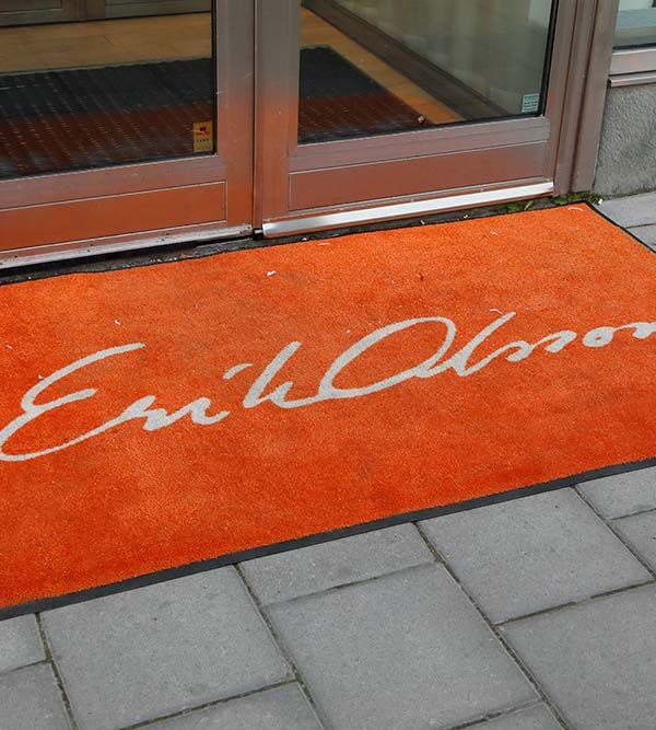 Stockholm, Sweden - July 7, 2016: Orange carpet outside the entrance to real estate broker Erik Olsson's office at the street Sveavagen.