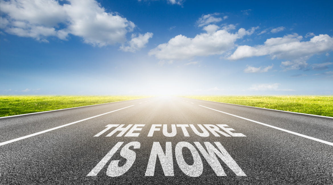 The Future of Real Estate Websites. Image showing "the future is now" text on asphalt road.